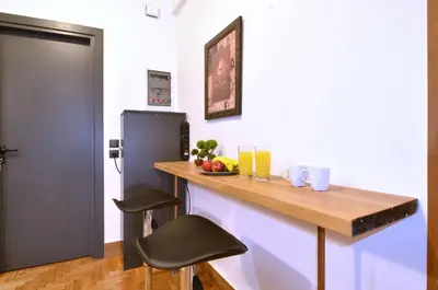 a kitchen with a wooden counter and a refrigerator at A modern rustic cosy apartment at the foot of Mount Lycabettus in Athens
