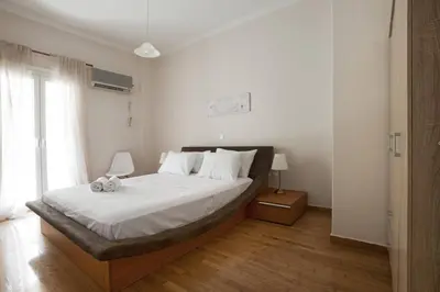 a bedroom with a large bed with white sheets at Pop art apartment at Koukaki in Athens