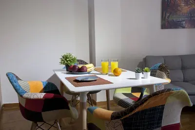 a white table with fruit on it in a living room at Pop art apartment at Koukaki in Athens