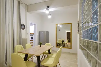 a dining room with a table and chairs and a mirror at Plaka, Apartment in the old historical neighborhood of Athens in Athens