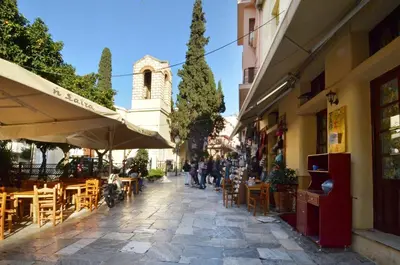 a street with tables and chairs and a building at Plaka, Apartment in the old historical neighborhood of Athens in Athens