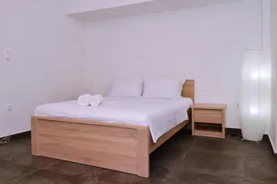 a bedroom with a bed with two towels on it at Koukaki, a minimal studio in Athens