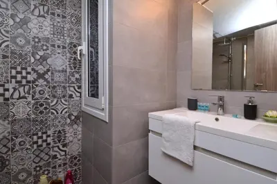 a bathroom with a sink and a mirror at Koukaki, a minimal studio in Athens