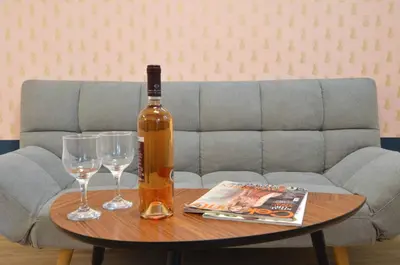 a bottle of wine and two glasses on a table at Petralona, a sweet and cozy apartment in Athens