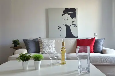a living room with a couch and wine glasses on a table at Kerameikos, a lovely apartment in Athens
