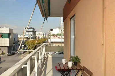 a balcony with a table and chairs on a building at Kerameikos, a lovely apartment in Athens
