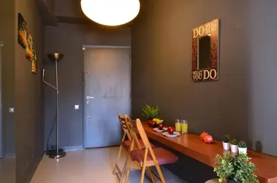 a dining room with a table and a sign on the wall at Kerameikos, a lovely apartment in Athens