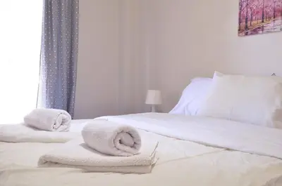 a bedroom with two towels on a bed at Kerameikos, a lovely apartment in Athens