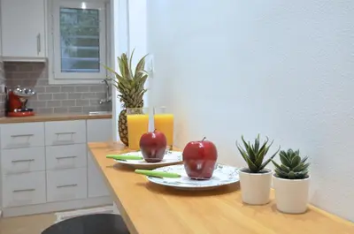 two apples on a table with two glasses of orange juice at Acropolis, a nice and minimal apartment in Athens