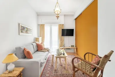 a living room with a couch and a chair at Chill Out In Retropolitan Hideaway at Alsos Park in Athens