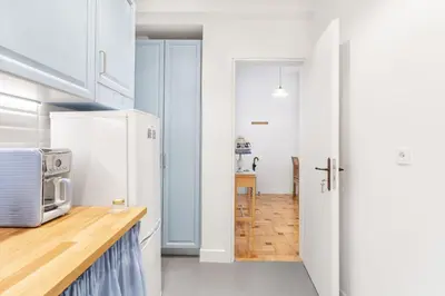 a kitchen with white cabinets and a microwave at Chill Out In Retropolitan Hideaway at Alsos Park in Athens