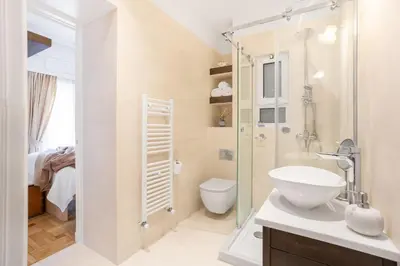 a bathroom with a shower and a toilet and a sink at Chill Out In Retropolitan Hideaway at Alsos Park in Athens