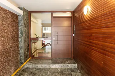 a hallway with a wooden door and a hallway with a car at Chill Out In Retropolitan Hideaway at Alsos Park in Athens