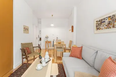 a living room with a couch and a table at Chill Out In Retropolitan Hideaway at Alsos Park in Athens