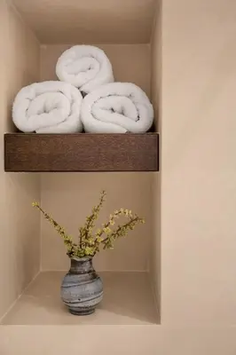 a shelf with three towels and a vase with a vase at Chill Out In Retropolitan Hideaway at Alsos Park in Athens