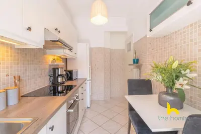 a kitchen and dining room with a table and chairs at Sun-splashed sanctum with big balconies, Acropolis 2 in Athens