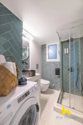 a washing machine in a bathroom with a shower at Sun-splashed sanctum with big balconies, Acropolis 2 in Athens