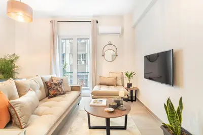 a living room with a couch and a tv at Stylish, 3-brdm Family Apartment near Acropolis! in Athens