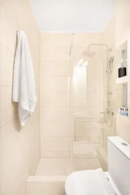 a white bathroom with a shower and a toilet at Stylish, 3-brdm Family Apartment near Acropolis! in Athens