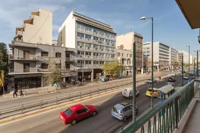 a busy city street filled with cars and buildings at Stylish, 3-brdm Family Apartment near Acropolis! in Athens