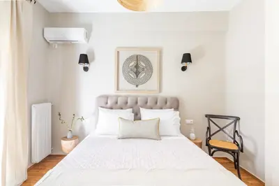 a bedroom with a large white bed with white pillows at Discover Athens from Urban Hideaway, Acropolis View in Athens