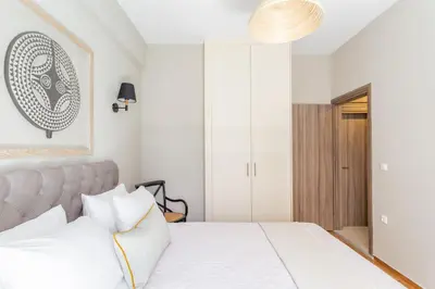 a bedroom with a white bed with white pillows at Discover Athens from Urban Hideaway, Acropolis View in Athens