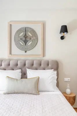 a bedroom with a bed with a picture above it at Discover Athens from Urban Hideaway, Acropolis View in Athens