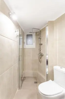 a bathroom with a toilet and a shower at Discover Athens from Urban Hideaway, Acropolis View in Athens