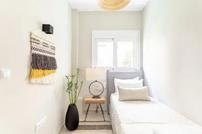 a bedroom with a bed and a clock on the wall at Discover Athens from Urban Hideaway, Acropolis View in Athens