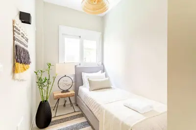 a white bedroom with a bed and a window at Discover Athens from Urban Hideaway, Acropolis View in Athens