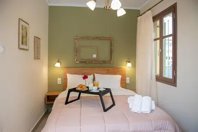 a bedroom with a bed with a table on it at Beautiful City Suites in Athens