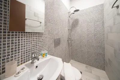 a bathroom with a sink and a toilet and a shower at Beautiful City Suites in Athens