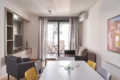 a living room with a table and chairs at Contemporary & Comfy Apt next to Acropolis Museum in Athens