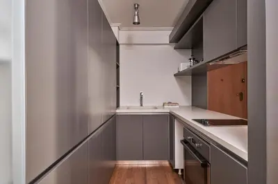 a kitchen with gray cabinets and a sink at Contemporary & Comfy Apt next to Acropolis Museum in Athens