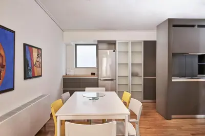 a kitchen and dining room with a white table and chairs at Contemporary & Comfy Apt next to Acropolis Museum in Athens