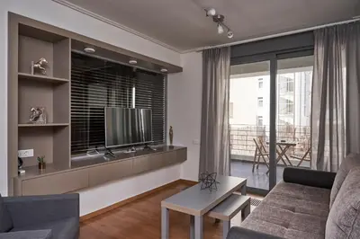 a living room with a couch and a tv at Contemporary & Comfy Apt next to Acropolis Museum in Athens