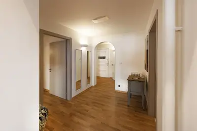a hallway of an apartment with white walls and wooden floors at Kolonaki 2 Bdr apartment in Athens
