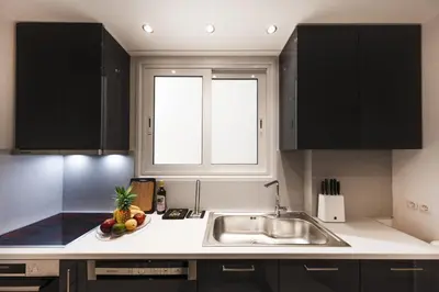 a kitchen with a sink and a bowl of fruit on the counter at Kolonaki 2 Bdr apartment in Athens