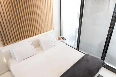 a small bed in a room with a window at Azelia Suites - Acropolis View in Athens