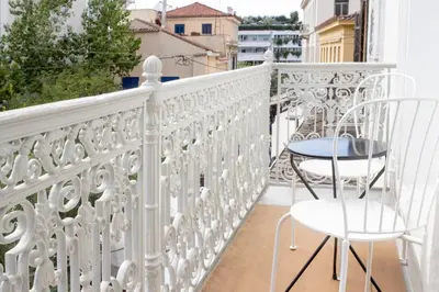 a white balcony with a table and chairs on it at Azelia Suites - Acropolis View in Athens