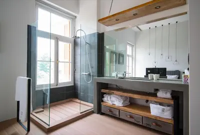 a bathroom with a glass shower and a sink at Azelia Suites - Acropolis View in Athens