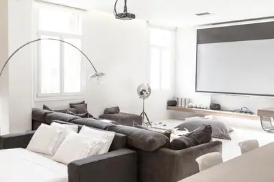 a living room with couches and a projection screen at Azelia Suites - Acropolis View in Athens