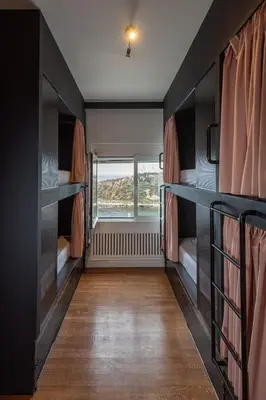 an empty room with bunk beds and a window at BEDWAVE Seaside Mansion in Piraeus