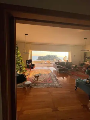 a living room with couches and a living room with a view at BEDWAVE Seaside Mansion in Piraeus