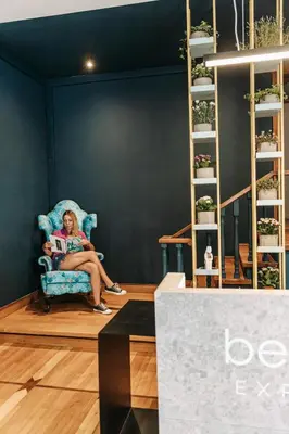 a woman sitting in a chair in a room at BEDWAVE Seaside Mansion in Piraeus
