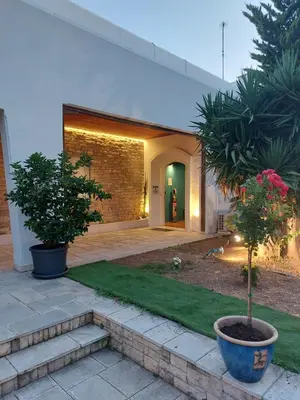 a house with two potted trees in a yard at BEDWAVE Seaside Mansion in Piraeus