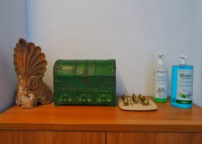 a wooden counter with a green box and a bottle of soap at Royal Blue Grand Suite No 3 in Piraeus