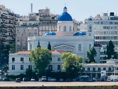 a white building with a blue dome on top of it at Royal Blue Grand Suite No 3 in Piraeus