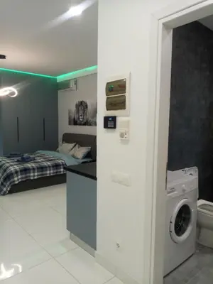 a bathroom with a washer and dryer in a room at SOFOKLEOUS 57, STUDIO KATERINA IN KALLITHEA. in Athens