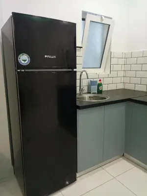 a black refrigerator in a kitchen with a sink at SOFOKLEOUS 57, STUDIO KATERINA IN KALLITHEA. in Athens